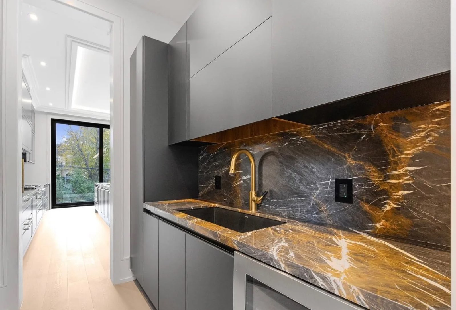 Wet bar with a stone counter and full-height stone backsplash
