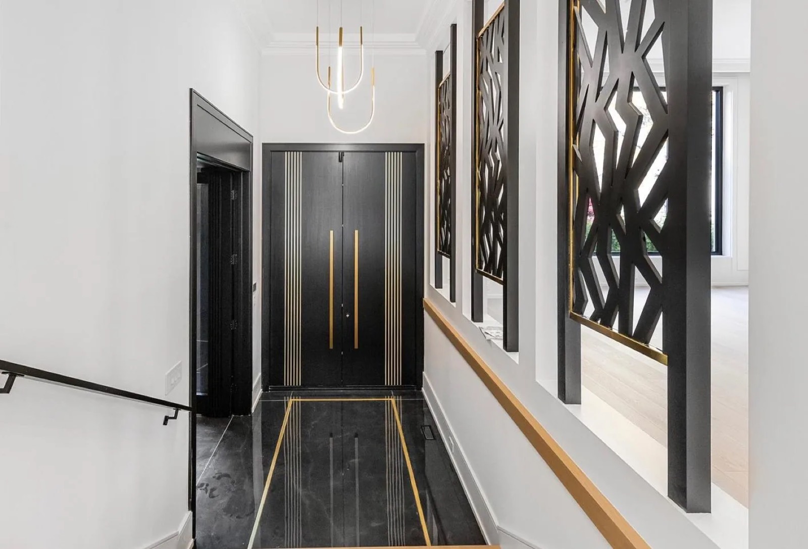 Entry hall with stone floor and custom panelled door